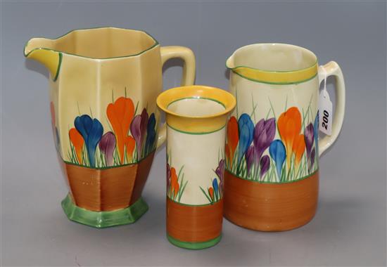 Two Clarice Cliff crocus pattern jugs and a Clarice Cliff brush pot tallest piece 21cm